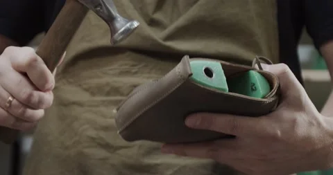 Close up view of tailor nailing and fixing blank for shoes in private leather Stock Footage 200127780