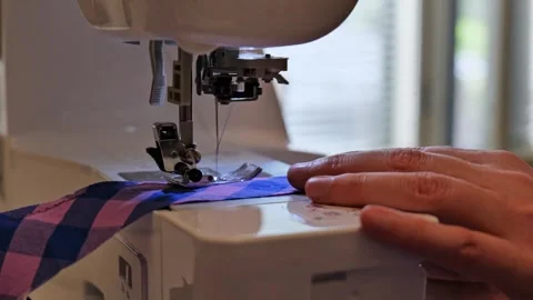 Close up view of tailor using sewing machine on fabric Stock Footage 345312934