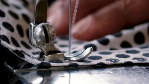 Close up view of tailor working in sewing denim jeans with sewing machine Stock Footage 120495768