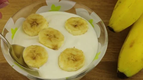 Close-up view of taking a spoonful of yogurt with banana fruit. Stock-Footage 151419254