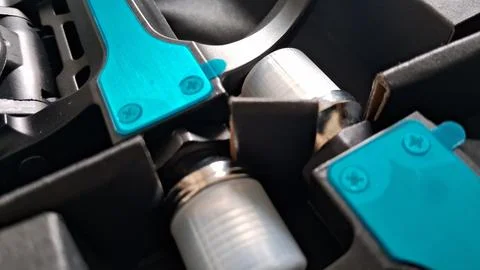 Close up view of teal metal components inside storage packaging box Stock Photos