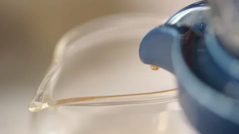 Close up view of teapot pouring tea in glass Stock Footage 261248632