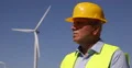 Close View Technical Engineer Foreground Supervising Wind Turbines installation 4k or 4k+ Resolution