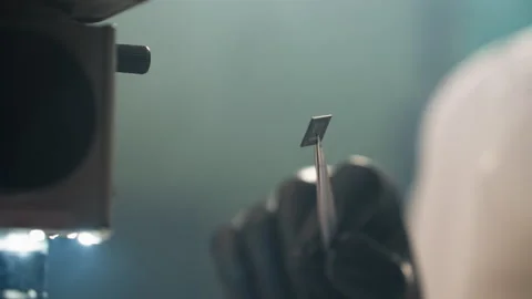 Close-Up View of Technician Examining Electronic Component with Tweezers Stock Footage 285405490