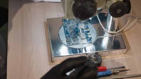 Close-Up View of Technician Soldering Circuit Board on Electronics Workbench Stock Footage 281373826