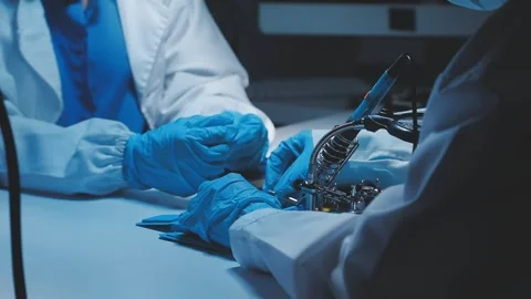 A close-up view of a technician wearing black gloves holding a computer pro.. Stock Footage 335104995