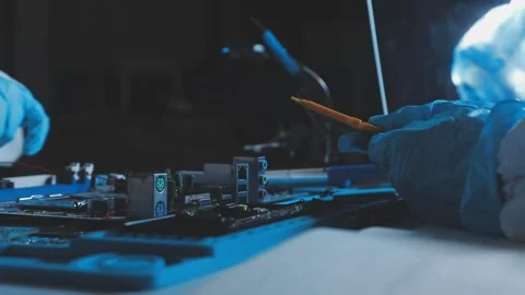 A close-up view of a technician wearing black gloves holding a computer pro.. Stock Footage 335105343