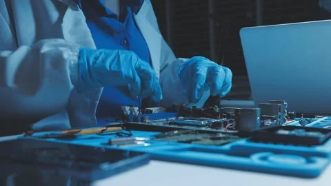 A close-up view of a technician wearing black gloves holding a computer pro.. Stock Footage 335105350