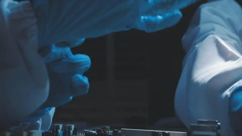 A close-up view of a technician wearing black gloves holding a computer pro.. Stock Footage 335105367
