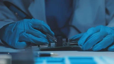 A close-up view of a technician wearing black gloves holding a computer pro.. Stock Footage 335105434