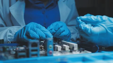 A close-up view of a technician wearing black gloves holding a computer pro.. Stock Footage 335105500