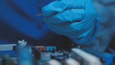 A close-up view of a technician wearing black gloves holding a computer pro.. Stock Footage 335105501