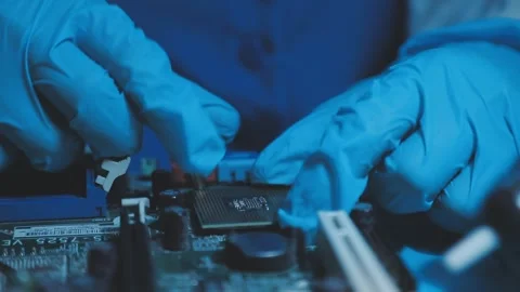 A close-up view of a technician wearing black gloves holding a computer pro.. Stock Footage 335105507