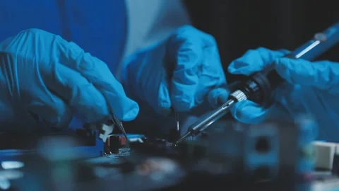 A close-up view of a technician wearing black gloves holding a computer pro.. Stock Footage 335105514
