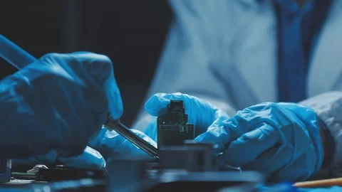 A close-up view of a technician wearing black gloves holding a computer pro.. Stock Footage 335105573