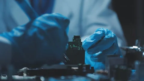 A close-up view of a technician wearing black gloves holding a computer pro.. Stock Footage 335105579