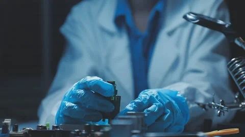 A close-up view of a technician wearing black gloves holding a computer pro.. Stock Footage 335105580