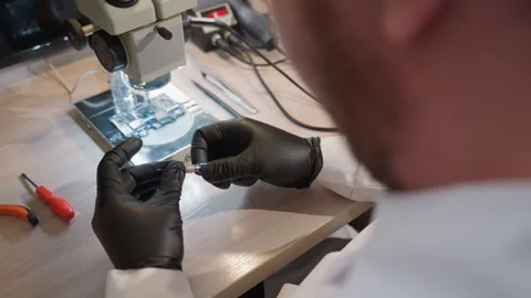 Close View of Technician Working on Circuit Board Under Microscope Stock Footage 281372615
