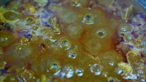 Close-up view of tender beef pieces coated in a rich, glossy brown curry sa.. Video stock 346466747