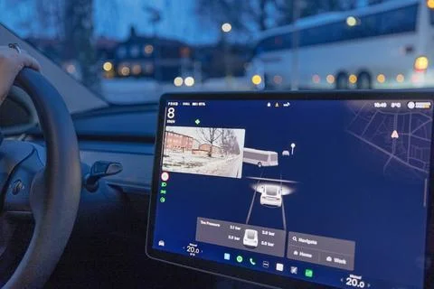 Close up view of Tesla Model Y interior with navigation screen showing bus Fotos de archivo