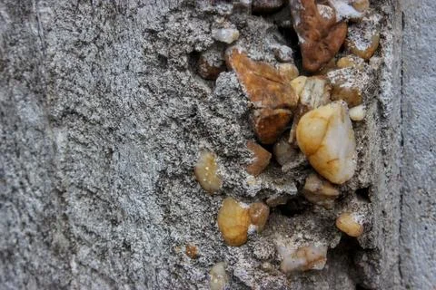 A close-up view of the texture of a concrete pillar on a house. Stock Photos