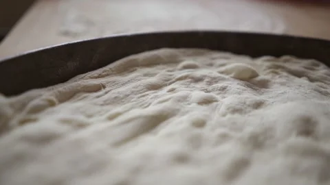 Close up view of the texture of a risen homemade pizza dough uncooked Stock Footage 155995903