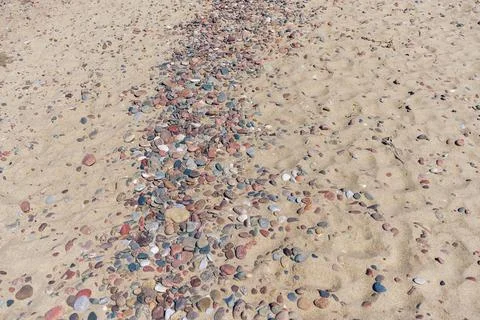Close view of texture of sand and pebbles on sunny day Stock Photos