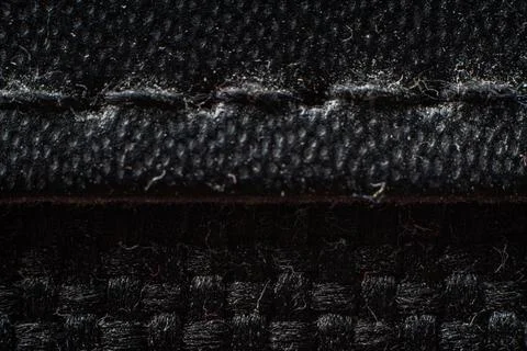 Close-up view of textured black fabric showcasing intricate weave patterns and Stock Photos