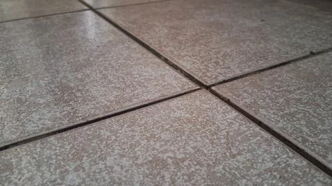 Close up view of textured brown ceramic floor tiles indoors Stock Photos