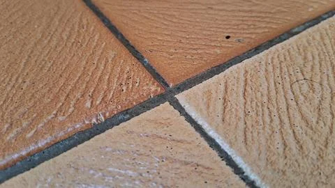 Close up view of textured brown ceramic floor tiles pattern Stock Photos
