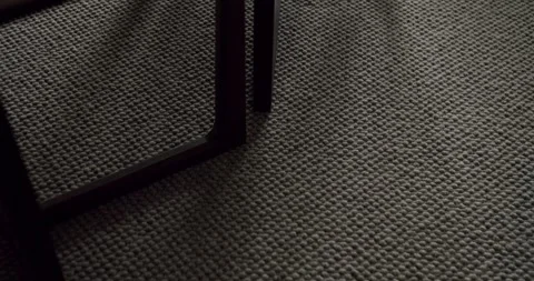 Close-up View of Textured Carpet with Table Leg in Soft Lighting Stock Footage 342805624