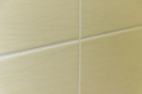 Close-up view of a textured ceramic tile, featuring subtle lines and patterns. Foto stock