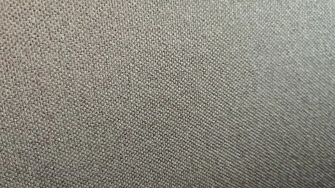 Close-up view of textured fabric showing detailed weave pattern, highlighting Stock Footage 332859233
