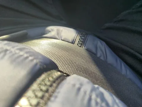 Close-up view of a textured fabric surface with shining elements under bright 스톡 사진