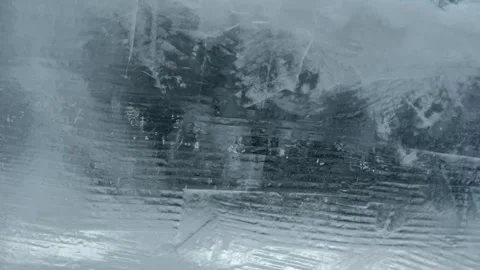 Close up view of textured frozen ice surface with natural light reflections Stock Footage 342028198