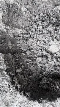 Close up view of a textured gray soil surface with uneven cracks and varying Stock Photos