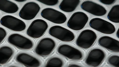 Close-up view of textured metal mesh material showcasing intricate patterns and Stock Footage 317554144