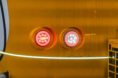 Close-up view of textured orange object with two symmetrical light fixtures.. Foto stock