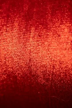 Close-up view of textured red fabric showcasing intricate weave patterns an.. Stockfoto's