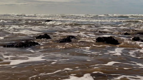 Close view of textured reef rocks and shallow water at Costa Ballena, revealing Stock Footage 321722319