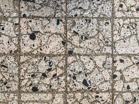 Close-up view of a textured stone floor with intricate patterns, exhibiting.. Stock Photos