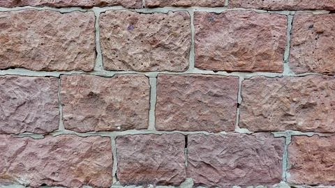 A Close-Up View of a Textured Stone Wall Featuring Weathered Brick Patterns Stock Photos
