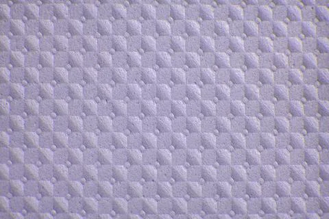 Close view of textured surface showing small squares and dots on a white Stockfoto's