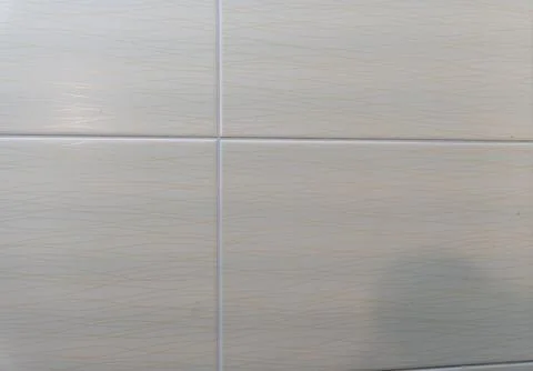 Close-up view of textured tiles with a subtle wave pattern, ideal for home decor 写真素材