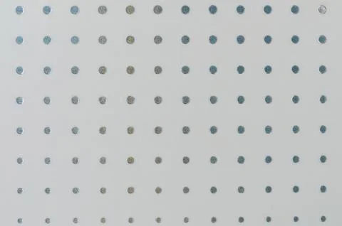 Close-up view of textured white surface with evenly spaced metallic dots Stock Photos