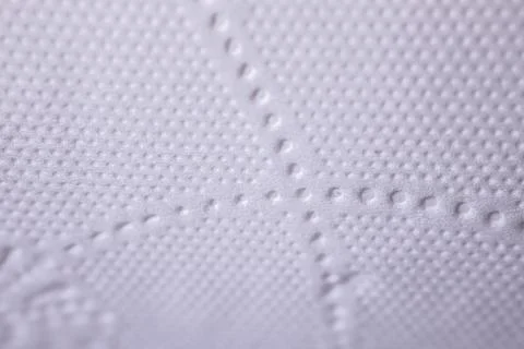 Close-up view of textured white surface featuring raised dots and lines, sh.. Stock Photos
