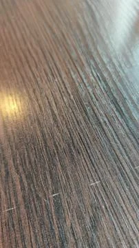 Close-up view of textured wooden table surface showing gradual changes in l.. Stock Photos