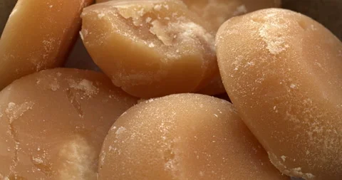 Close-up view of Thai palm sugar blocks on a plate. Table spin. Stock Footage 278516065
