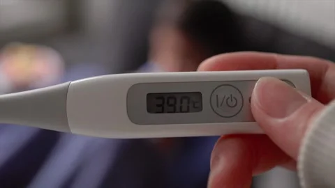 Close-up view of a thermometer showing a high temperature against a blurry Stock Footage 244634764