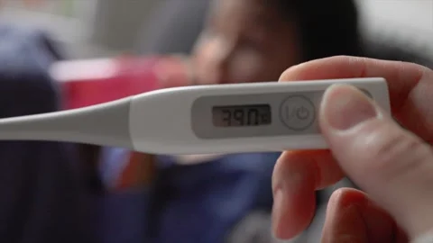 Close-up view of a thermometer showing a high temperature against a blurry Stock Footage 244825977